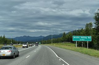 A single exit ramp links SR 1 (Glenn Highway) northbound with Artic Valley Road east.