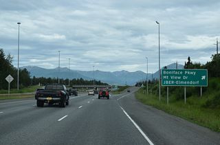 A parclo interchange joins SR 1 (Glenn Highway) with Boniface Parkway south and the Boniface Gate into Joint Base Elmendorf-Richardson.