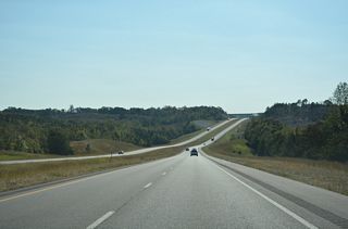 Rural scenery along Interstate 22 east ahead of the Scuffle Grit Road overpass.