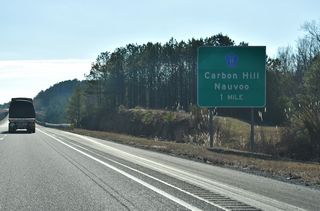 Walker County Route 11 stems northeast from 1st Street in Carbon Hill along Nauvoo Road to the diamond interchange at Exit 46.