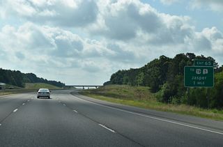Interstate 22 next meets Industrial Parkway at a diamond interchange (Exit 65) in one mile.