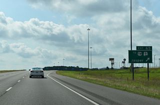 Exit 65 leaves I-22/U.S. 78 east for Industrial Parkway. The five lane boulevard represented a temporary alignment for U.S. 78 until the Jasper to Graysville section opened to traffic.