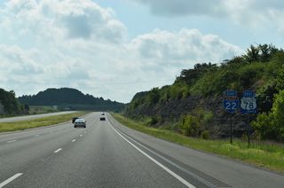 Whitehouse and West Lake Roads parallel Interstate 22 above rock cuts to the south of Walker County Lake by this shield assembly.