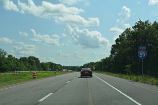 Southbound reassurance marker posted after Exit 205. Frontage roads (Industrial Lane / Briarwood Avenue) accompany the freeway to County Route 51 (Lebanon Road).