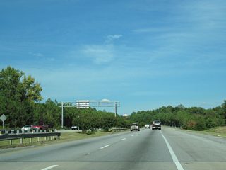 U.S. 80 spans Railroad Street and a Norfolk Southern Railroad line just east of roadway stubs at the end of J.R. Allen Parkway.