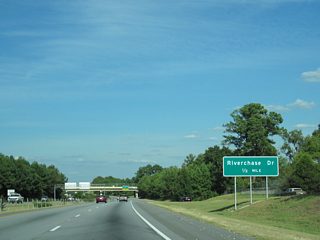 Continuing east, U.S. 80 (J.R. Allen Parkway) passes under 13th Avenue on the half mile approach to a folded diamond interchange with River Chase Drive.