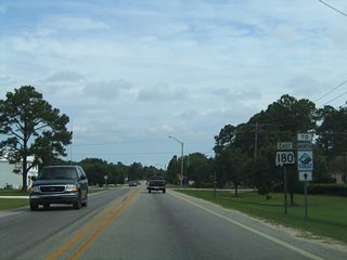 Reassurance shield and trailblazer assembly for SR 180 east and the Foley Beach Express posted along East 2nd Street north after 21st Avenue. The 2000-opened Foley Beach Express provides a second route to the Baldwin County mainland.