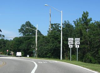 SR 135 traveled 2.1 miles southeast from SR 180 through Gulf State Park. SR 135 appeared on the state highway map as SR 138 by 1948, at the same time SR 180 east of SR 59 (then SR 3) was numbered SR 160. Changes to the current numbering system were made by 1957.