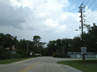 The previous end sign for SR 180 was posted at the Canal Road intersection with Mississippi Avenue and Perdido Gate Drive.