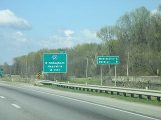 The lone remaining distance sign along the Huntsville freeway spur lists Mooresville and Decatur at the crossing of Limestone Slough.