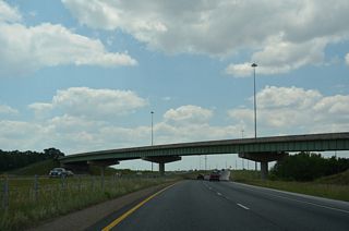 Entering Limestone County at the County Line Road overpass, I-565/U.S. 72 Alternate proceeds west through the original wye interchange with Madison Boulevard.
