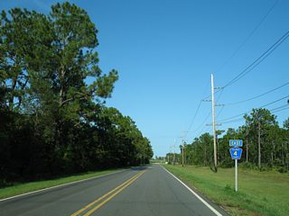 CR 4 reassurance marker posted on Brown Lane after Roscoe Road. Cotton Creek Road comprises the main access road to the sprawling Craft Farms golf course subdivision community.