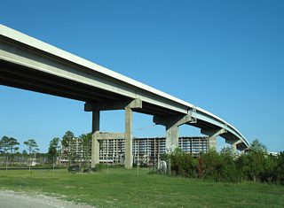 Construction along the south side of the Intracoastal related to The Wharf rises to encompass the view of Browns Lane on the eastward turn under the toll bridge. A long delayed development lines the north side of the Intracoastal adjacent to the Foley Beach Express. Partially built structures associated with Bama Bayou occupied areas east of the toll plaza for years.