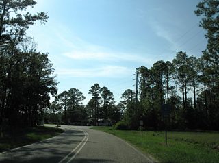 CR 4 concludes at CR 6. County Road 6 spurs west onto Plash Island and arcs northeast along the Bon Secour River to Pak and SR 59 (Gulf Shores Parkway).