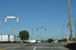 5th Avenue N emerges from the tunnel through an industrial area at 28th Street N.