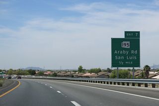 Interstate 8 curves west by suburban development to the dumbbell interchange (Exit 7) with SR 195 (Araby Road) south. Araby Road extends 1.4 miles north from Exit 7 to U.S. 95 by El Prado Estates.