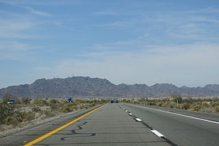 Interstate 8 eventually crosses the distant Gila Mountains into the Colorado River valley at the Yuma Desert.
