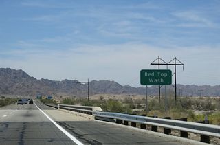 Interstate 8 crosses Red Top Wash south of a power substation.
