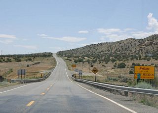 A short four miles after Teec Nos Pos, U.S. Highway 64 enters New Mexico here.
