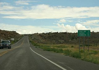 Distance sign to the Arizona State Line and Shiprock, NM.
