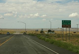 Approaching U.S. 160, travelers can continue west to reach Kayenta, or turn right to take U.S. 160 toward Cortez or Four Corners Monument.