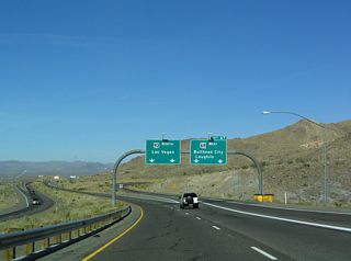 Two lanes depart from U.S. 93 northbound at Exit 67 for SR 68 west. An Arizona Port of Entry facility operates within this exchange for southbound traffic.
