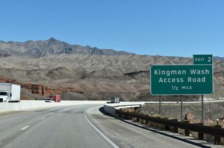 The Hoover Dam Bypass crosses the former alignment of U.S. 93 north to Hoover Dam a half mile from the diamond interchange (Exit 2) with Kingman Wash Access Road.