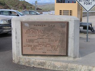 A plaque on the west side of Parker Dam describes the design specifications of the 320 foot high structure.