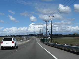 Continuing north from the bridge built in 1967 over Anaheim Bay, California 1 skirts the edge of Seal Beach National Wildlife Refuge and a United States Naval Weapons Station.