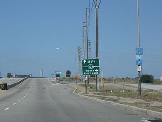 Pacific Coast Highway [PCH] advances west by the Westside neighborhood in Long Beach to a cloverleaf interchange with SR 103 (Terminal Island Freeway).