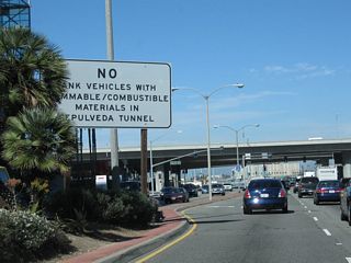After the intersection with Walnut Avenue, a warning sign advises of the restrictions associated with Sepulveda Tunnel, which carries California 1 (Sepulveda Boulevard) under the southern east-west runway of Los Angeles International Airport (LAX). The elevated viaduct ahead carries Interstate 105 (Glenn Anderson Freeway) over California 1.