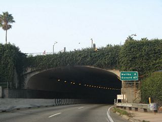 Built between 1935 and 1939 as part of U.S. 101 Alternate, the Robert E. McClure (Palisades) Tunnel is a historic resource in the greater Los Angeles transportation network. The tunnel is not wide enough to meet Interstate standards and thus is not a part of I-10. However, it is part of a dramatic and fitting end to a transcontinental route.