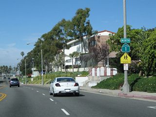 A California 1 north reassurance shield is posted after the Emerald Street intersection.