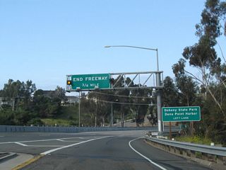 California 1 merges in with traffic from Camino las Ramblas. After the Exit 1 interchange, this freeway segment of California 1 will end (in about 0.75 mile). Follow California 1 north to Dana Harbor and Doheny State Beach.