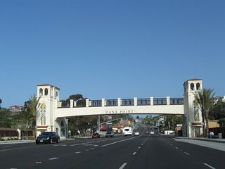 The PCH passes under a pedestrian bridge and arch to welcome visitors to the city of Dana Point ("Harboring the Good Life"). Dana Point had a population of 35,110 as of the 2000 Census; the city incorporated on January 1, 1989. The downtown area around Dana Point Harbor through which many of the "Streets of the Lantern" pass, is known as the Lantern District.
