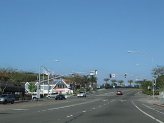 Coast Highway intersects Street of the Blue Lantern to the immediate west of Del Prado Avenue (former SR 1 south).