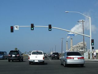 Northbound California 1 (Pacific Coast Highway) meets Magnolia Street at this traffic signal. Magnolia Street also travels north toward Edison Community Park and the city of Fountain Valley.