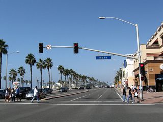 After passing First Street, northbound California 1 (Pacific Coast Highway) meets Main Street in downtown Huntington Beach. Turn right onto Main Street north to the central business district, complete with restaurants, bars, and gift shops. On-street parking and parking lots are available. The Huntington Beach Pier, which extends southwest over the ocean, offers fishing and sightseeing opportunities. The pier begins at this intersection.
