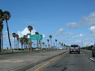 After the intersection with Golden West Street, a sign in the median indicates California 1 (Pacific Coast Highway) is also U.S. Submarine Veterans of World War II Highway.