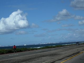 Looking northwest out over the water, the skyline of Long Beach comes into view, including the cruise ship terminal, port of Long Beach, Queen Mary, and towering skyline.