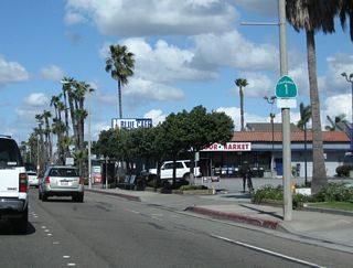 A California 1 north reassurance shield assembly is posted after the intersection with Warner Avenue.