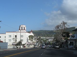 Morning fog continued to burn off as California 1 proceeds northwest into downtown Laguna Beach. The picturesque Hotel Laguna comes into view on the west side of the Coast Highway.