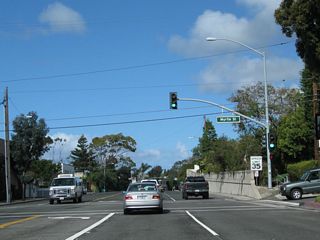 Northbound California 1 meets Myrtle Street at this traffic signal. An old retaining wall, dating to the 1930s, is located on the northeast side of the Coast Highway.