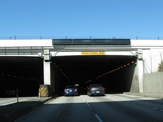 California 1 (Sepulveda Boulevard) enters Sepulveda Tunnel, which allows the southern runway of the Los Angeles International Airport to cross over Sepulveda Boulevard. This tunnel was built to allow the longer southern runways accommodate larger airplanes. Not to be confused with the Sepulveda Tunnel in the Santa Monica Mountains, the tunnel at LAX Airport carries three lanes in each direction and is approximately 1,900 feet long.