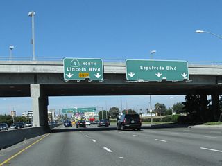 North of Vicksburg Avenue, SR 1 parts ways with Sepulveda Boulevard. Replaced in stages by Interstate 405, historically SR 7 followed Sepulveda Boulevard from here north to Sylmar. This iteration of SR 7 was eliminated in 1964 when many state routes were renumbered. This intersection was realigned due to airport expansion, so it does not represent the original south end of SR 7 7.