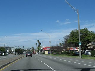 Long Beach city bike route signs mark major bike routes through the city. The Pacific Coast Highway route is aptly designated as Bike Route 1. Signs for the bike route are posted, even though a reassurance shield for California 1 should be here and is missing.