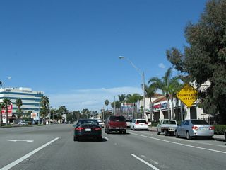 After the Clark Avenue intersection, a large sign is posted advising motorists of the upcoming Los Alamitos Traffic Circle, which was built in 1930 and converted to a modern style roundabout in 1993.