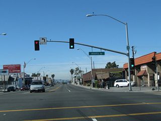 Atlantic Avenue heads south to Downtown Long Beach and waterfront attractions. This intersection also represents the former west end of U.S. 6. Formerly a transcontinental route, U.S. 6 overlapped with SR 1 west to Figueroa Street, and later the Harbor Freeway, before turning north toward Downtown Los Angeles and points northeast.