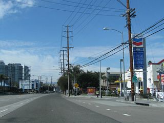 A California 1 reassurance shield is posted after Mindanao Way. Two sets of power lines parallel this stretch of California 1; the ones on the left are Los Angeles Department of Water and Power, while the ones on the right are Southern California Edison.