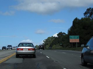 Northbound California 1 (Coast Highway) approaches Newport Coast Drive. Follow Newport Coast Drive east to Toll California 73.